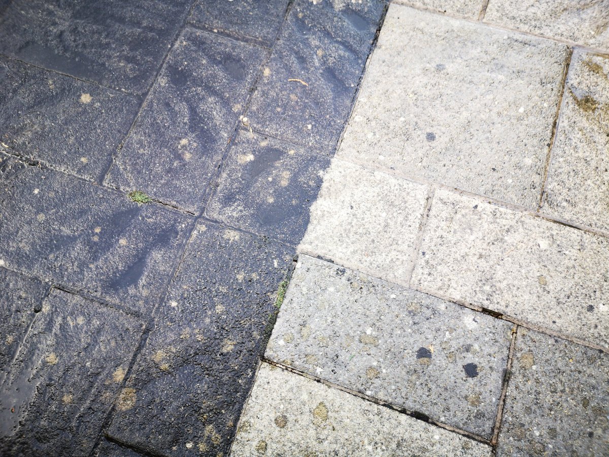 Close up of before and after patio cleaning with high pressure water jet wash